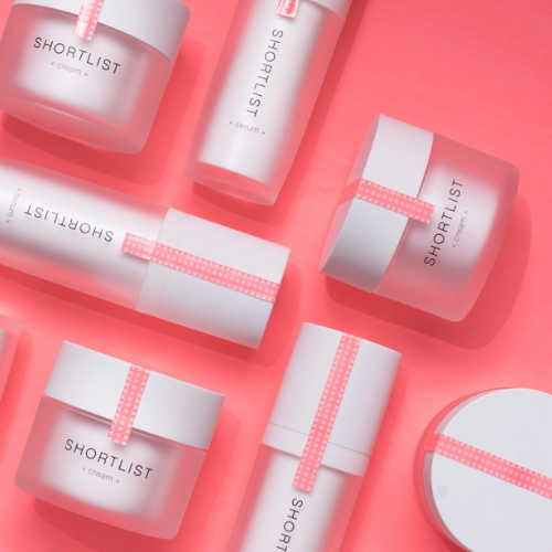 Shortlist products on a coral pink background